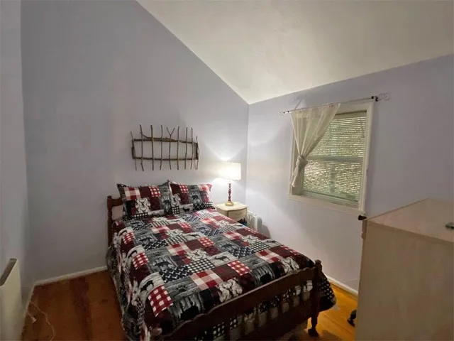 a bed sitting in a bedroom next to a window