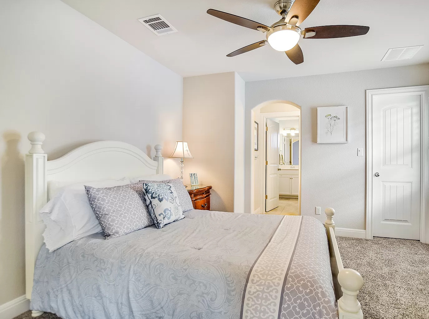 15621 Cabrillo Way Austin, TX 78738 - Photo 15 of 21 a bedroom with a bed and a chandelier