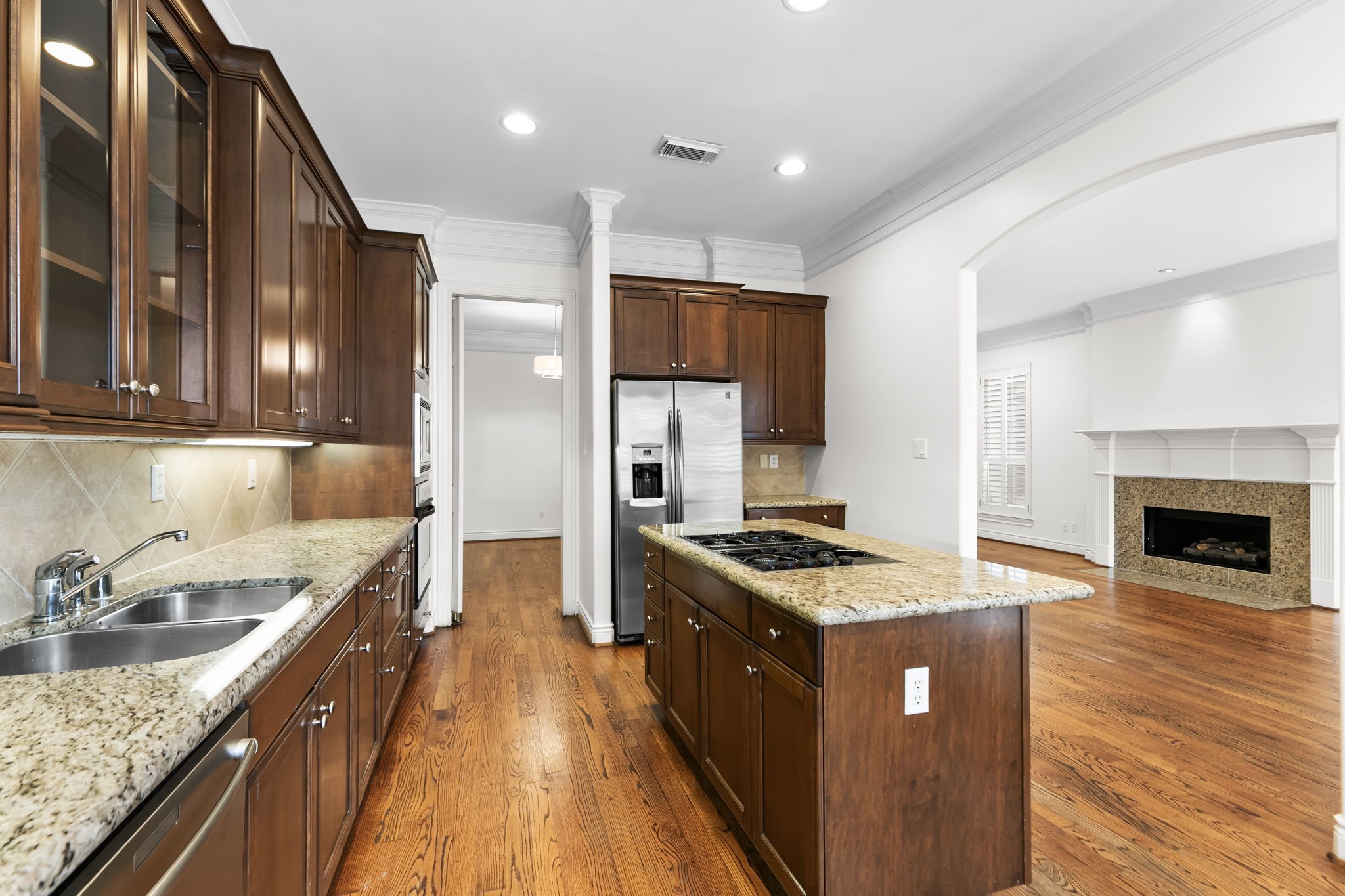 4026 Gramercy Street Houston, TX 77025 - Photo 11 of 35 a kitchen with stainless steel appliances granite countertop a stove a sink and a refrigerator