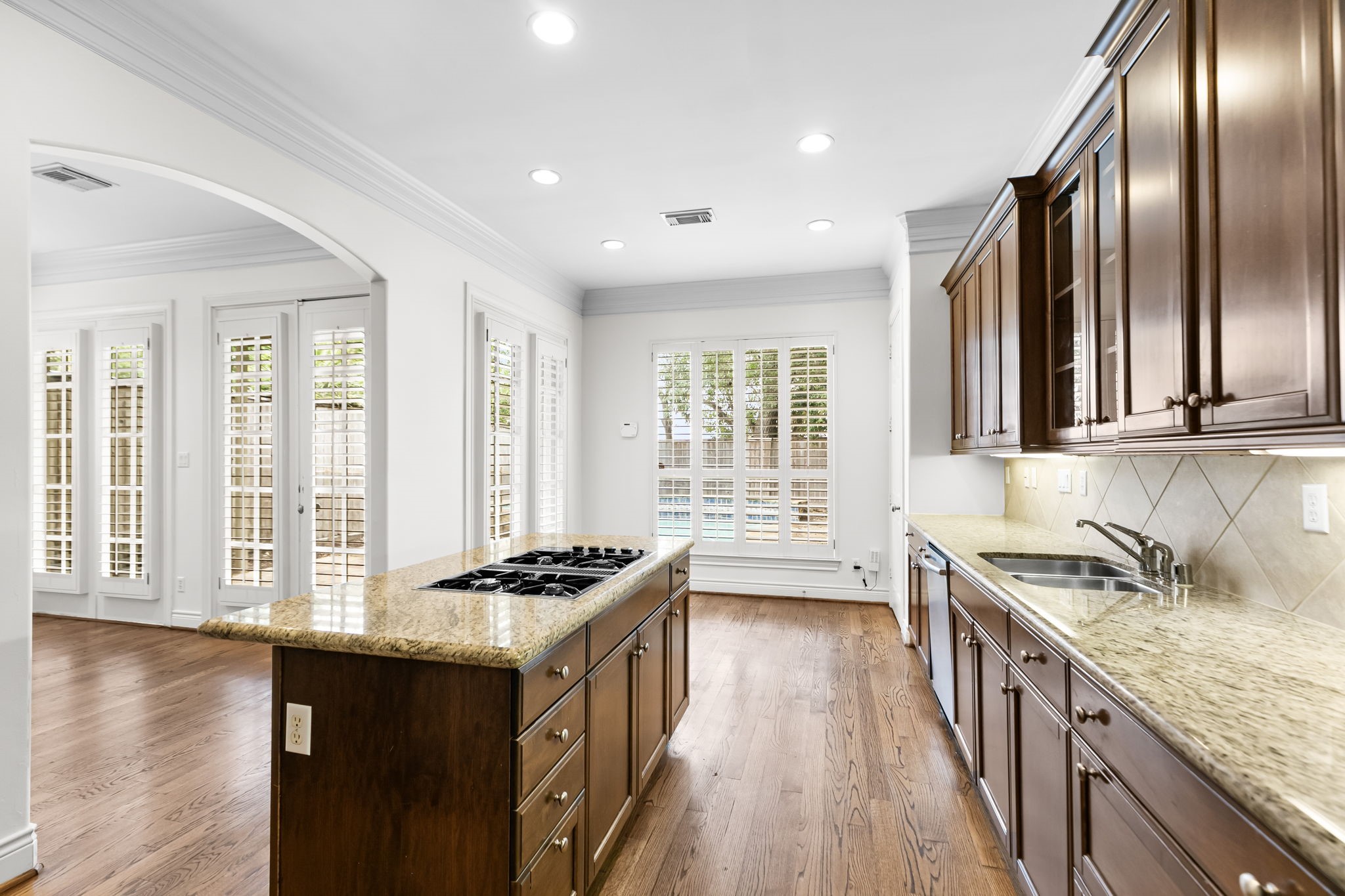 4026 Gramercy Street Houston, TX 77025 - Photo 12 of 35 a kitchen with stainless steel appliances granite countertop a stove a sink dishwasher a refrigerator and wooden floor