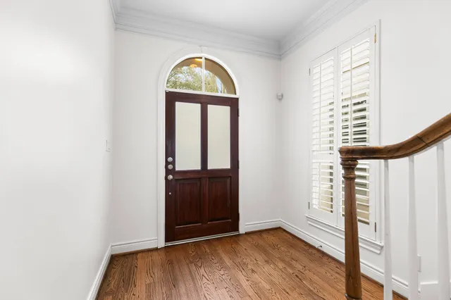 an empty room with wooden floor and a window