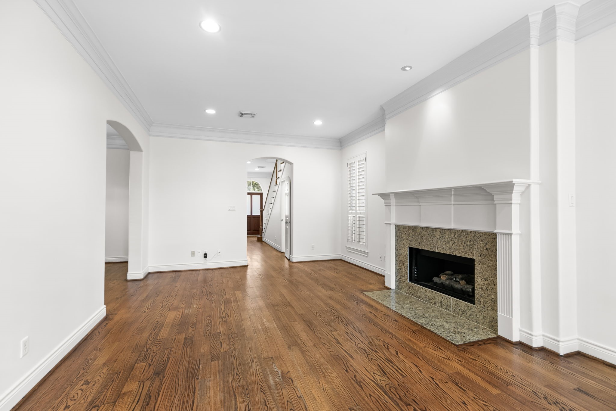 4026 Gramercy Street Houston, TX 77025 - Photo 7 of 35 a view of an empty room with wooden floor fireplace and a window