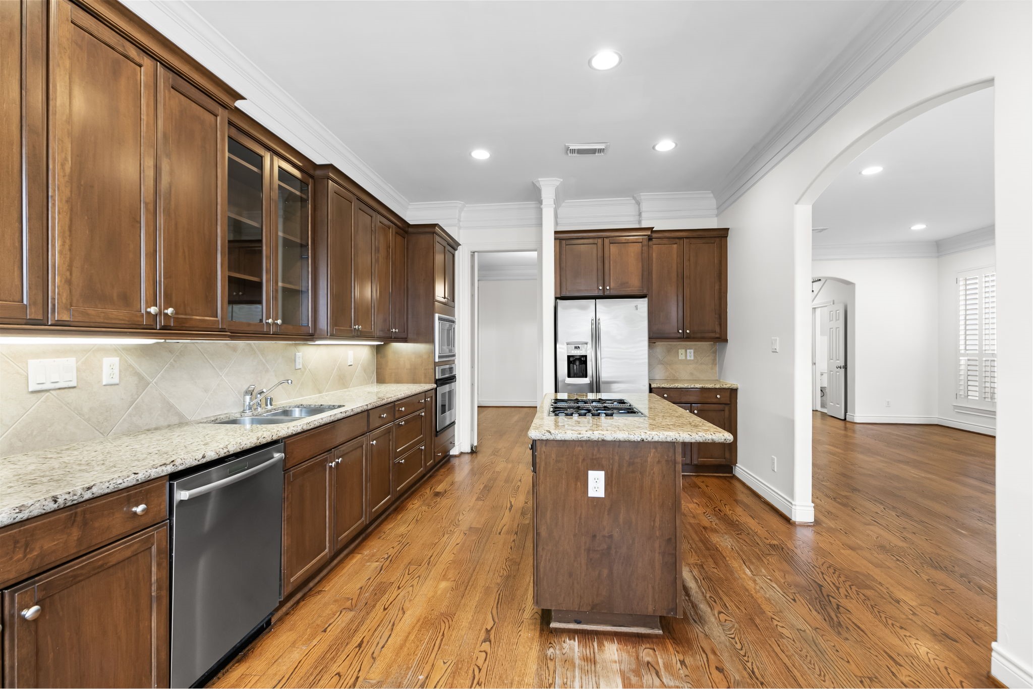 4026 Gramercy Street Houston, TX 77025 - Photo 10 of 35 a large kitchen with stainless steel appliances granite countertop a large counter top a stove and a sink