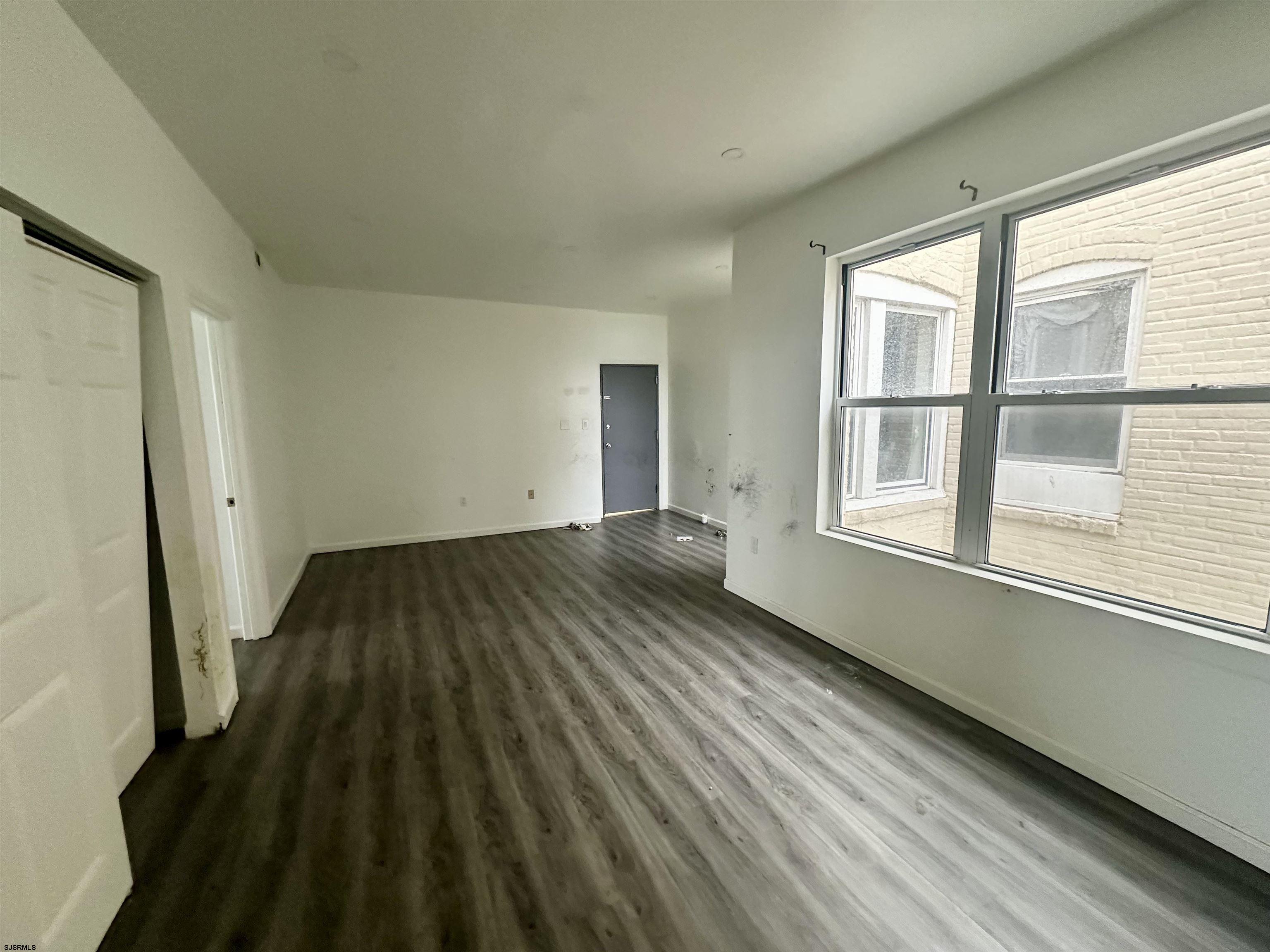225 Atlantic Avenue, Unit A6 Atlantic City, NJ 08401 - Photo 23 of 29 a view of empty room with wooden floor and fan