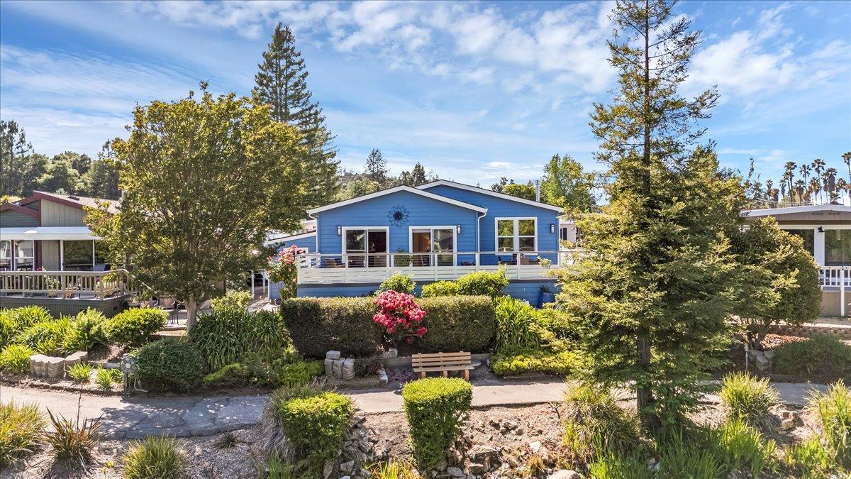 a front view of a house with a yard and fountain in middle