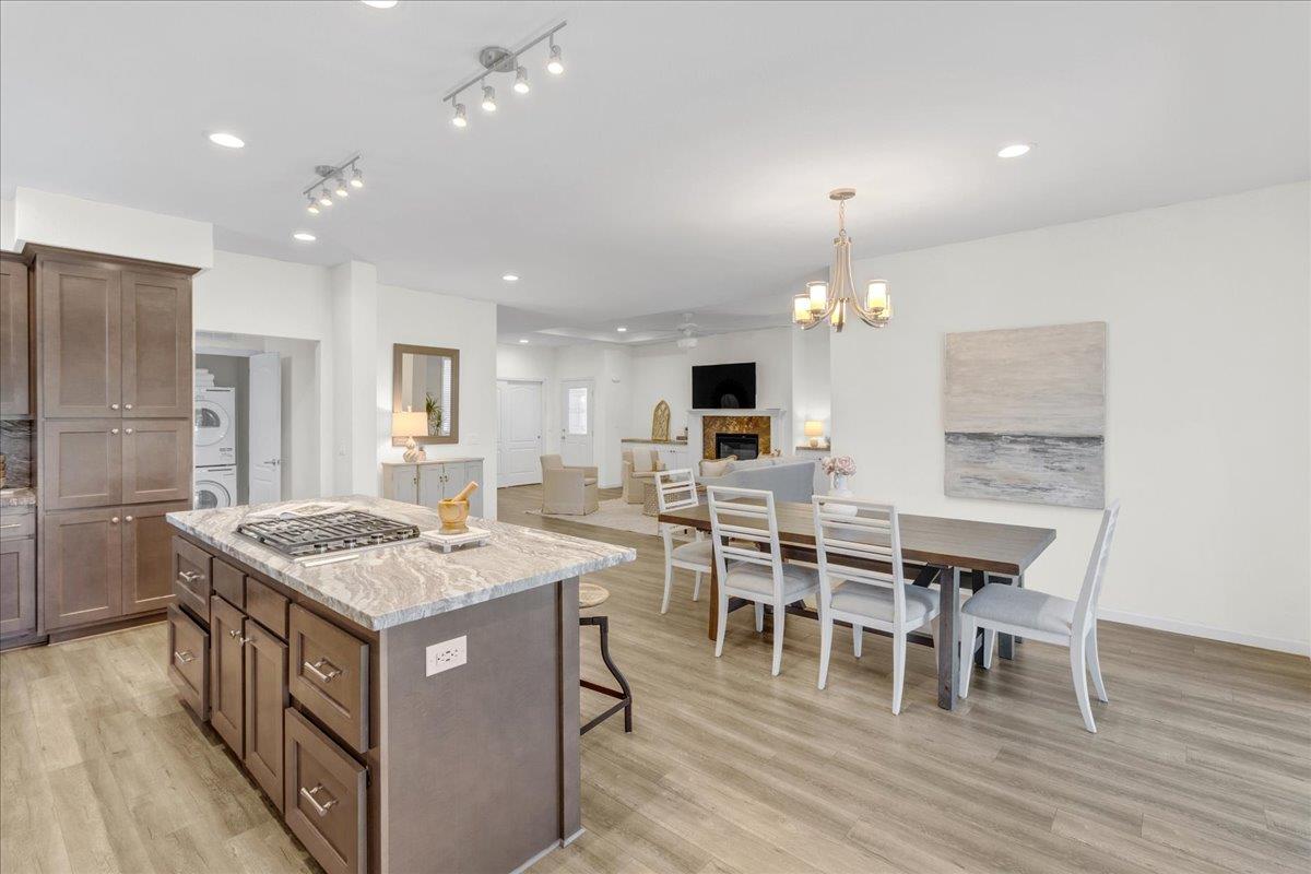 225 Mt Hermon Road, Unit 88 Scotts Valley, CA 95066 - Photo 14 of 50 a kitchen with a dining table chairs cabinets wooden floor and appliances