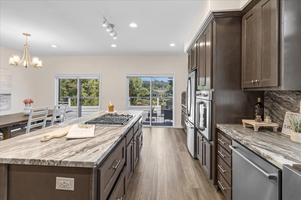225 Mt Hermon Road, Unit 88 Scotts Valley, CA 95066 - Photo 15 of 50 a kitchen with kitchen island granite countertop a sink stove and refrigerator