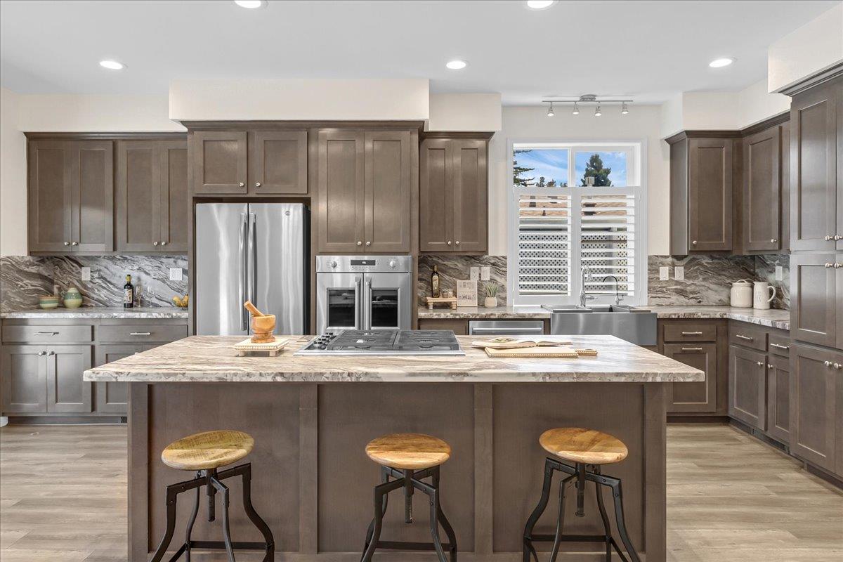 225 Mt Hermon Road, Unit 88 Scotts Valley, CA 95066 - Photo 17 of 50 a kitchen with stainless steel appliances granite countertop a table chairs sink refrigerator and microwave