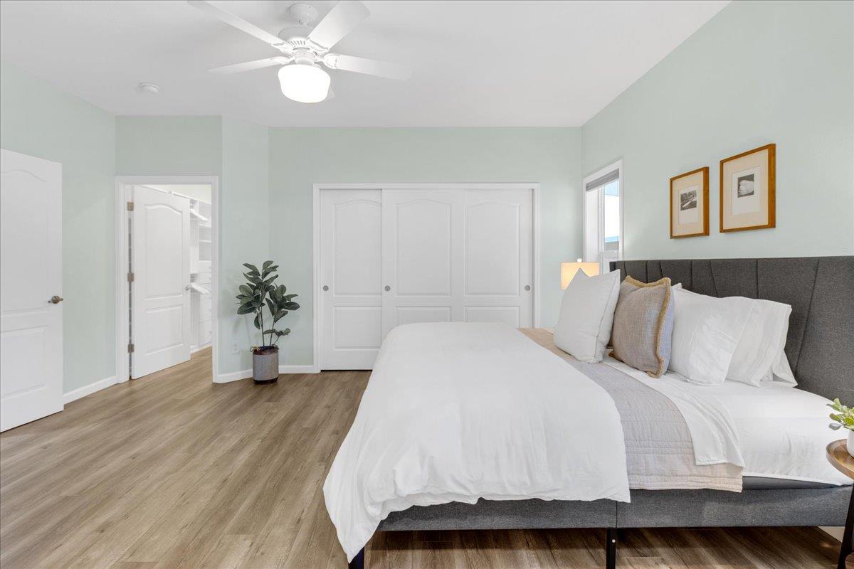 225 Mt Hermon Road, Unit 88 Scotts Valley, CA 95066 - Photo 22 of 50 a spacious bedroom with a bed and a chandelier
