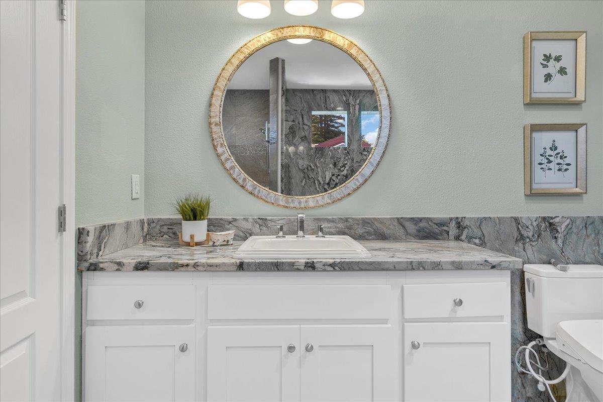 225 Mt Hermon Road, Unit 88 Scotts Valley, CA 95066 - Photo 26 of 50 a bathroom with a granite countertop sink and a mirror