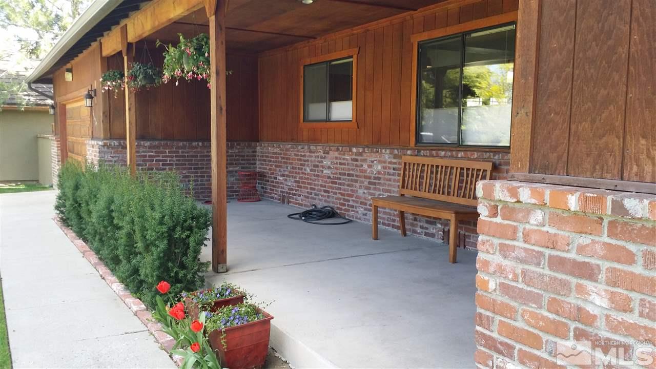 a front view of a house with outdoor seating