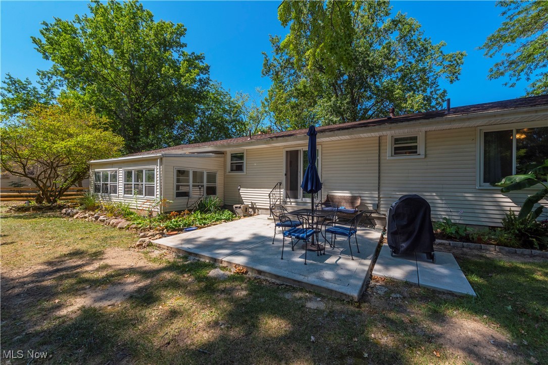 3615 Kolbe Road Lorain, OH 44053 - Photo 26 of 33 Rear view of house featuring a lawn and a patio area