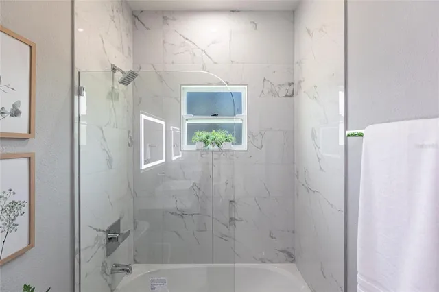 a bedroom with bed and a large mirror