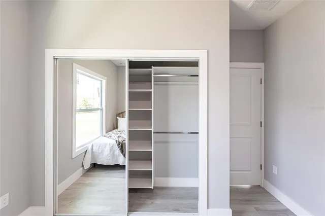a bedroom with a large bed couch and a window