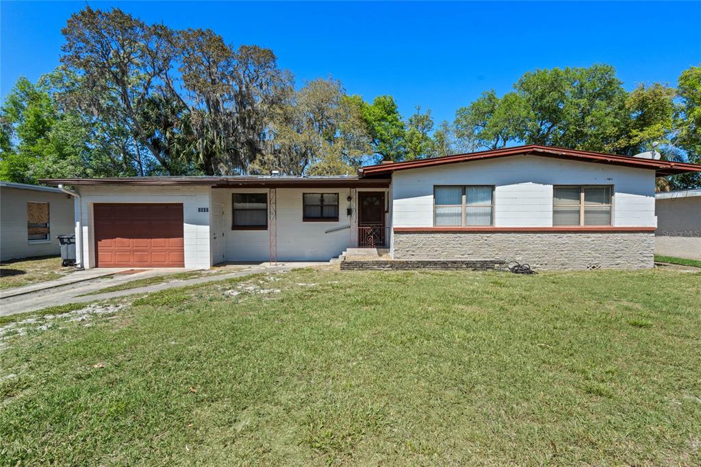 a front view of house with yard and trees