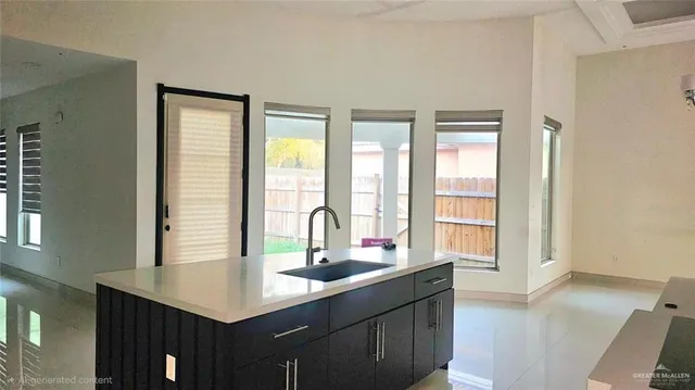 a kitchen with counter top space and living room view