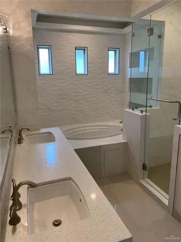 a bathroom with a tub and a shower
