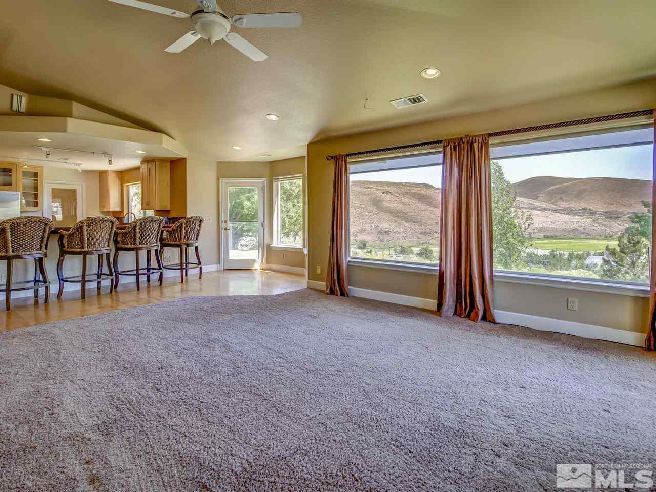 20575 Cooke Drive Reno, NV 89521 - Photo 3 of 25 a big room with windows and chandelier