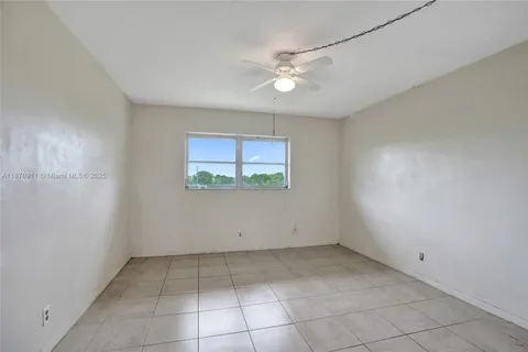 an empty room with a fan