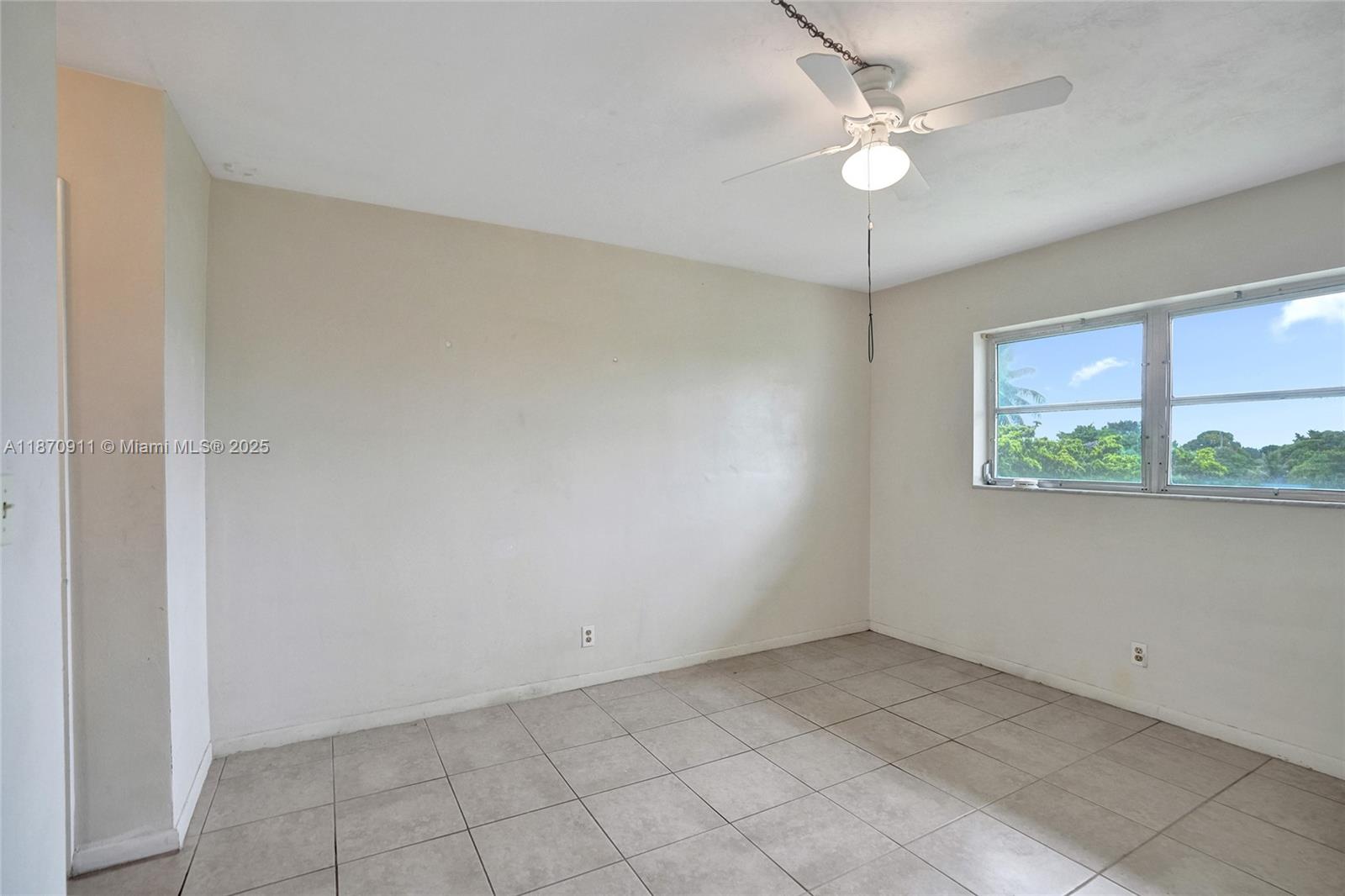 4731 Northwest 10th Court, Unit 314 Plantation, FL 33313 - Photo 16 of 26 an empty room with a window