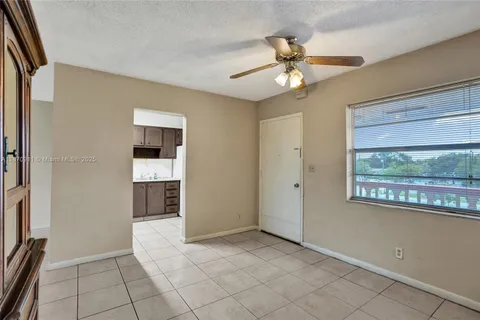 a view of a livingroom with a ceiling fan and window