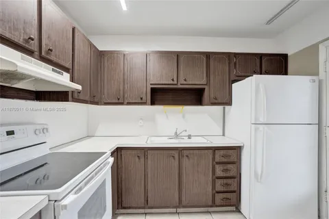 a kitchen with a sink a stove and a refrigerator