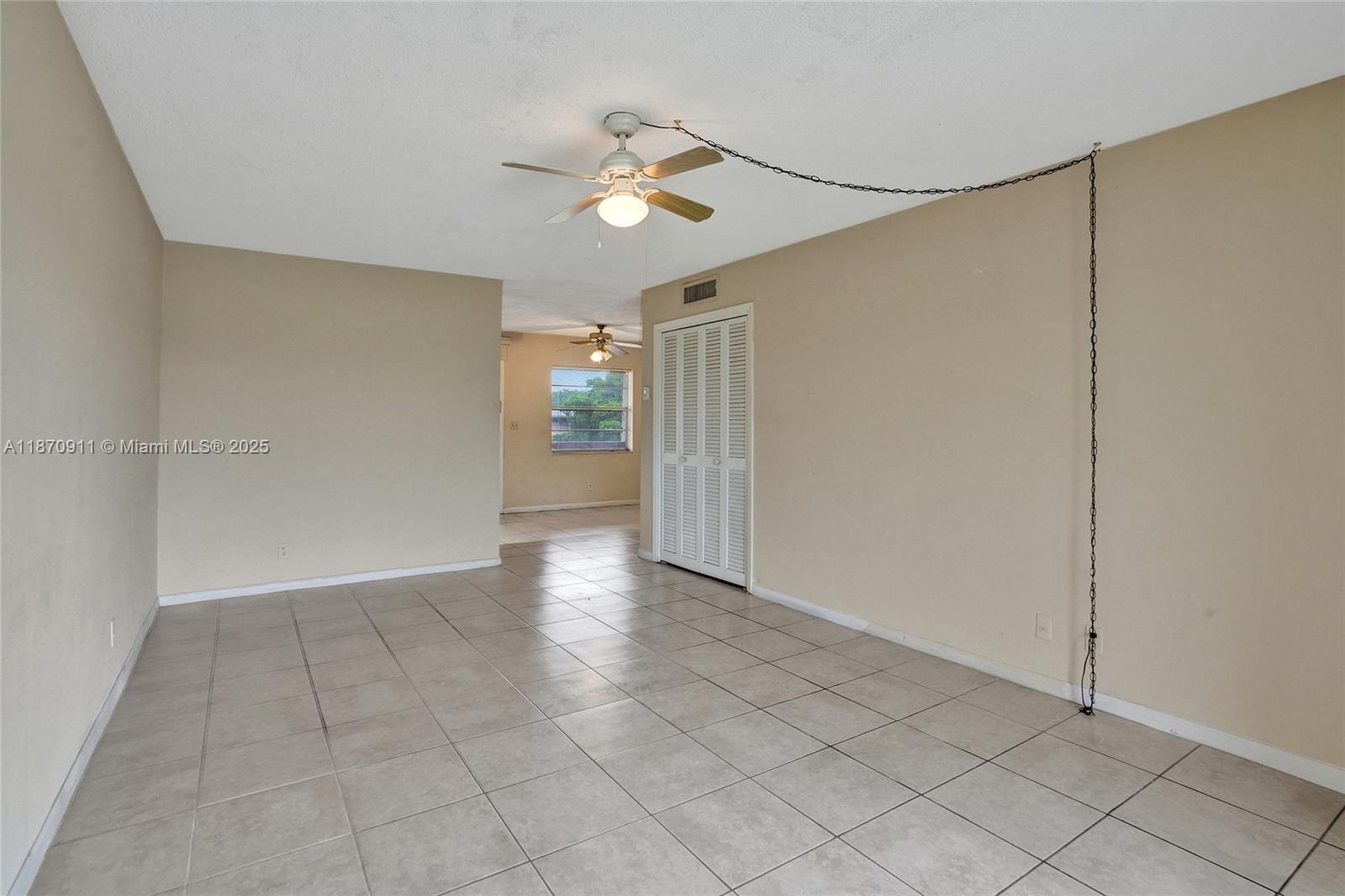4731 Northwest 10th Court, Unit 314 Plantation, FL 33313 - Photo 10 of 26 a view of an empty room and chandelier fan