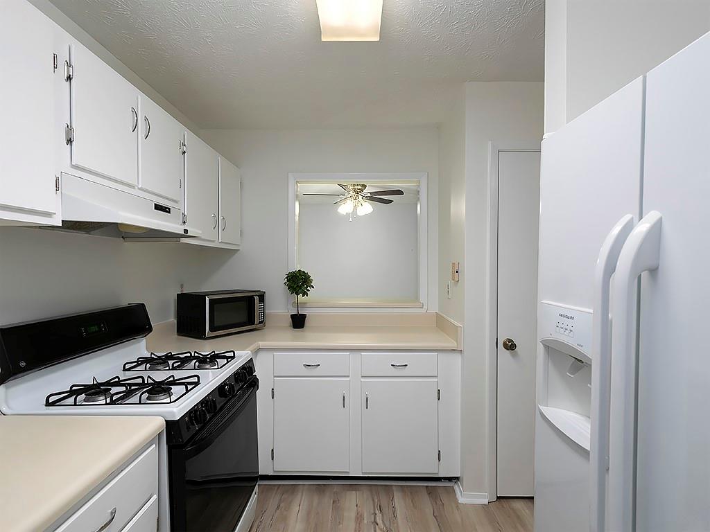 1316 Wynnes Ridge Circle Southeast Marietta, GA 30067 - Photo 13 of 29 a kitchen with white cabinets and white appliances