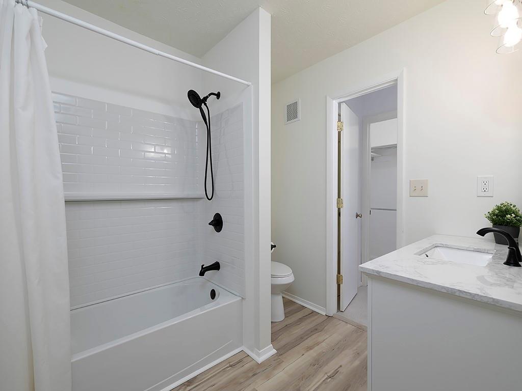 1316 Wynnes Ridge Circle Southeast Marietta, GA 30067 - Photo 16 of 29 a bathroom with a granite countertop sink a toilet and shower
