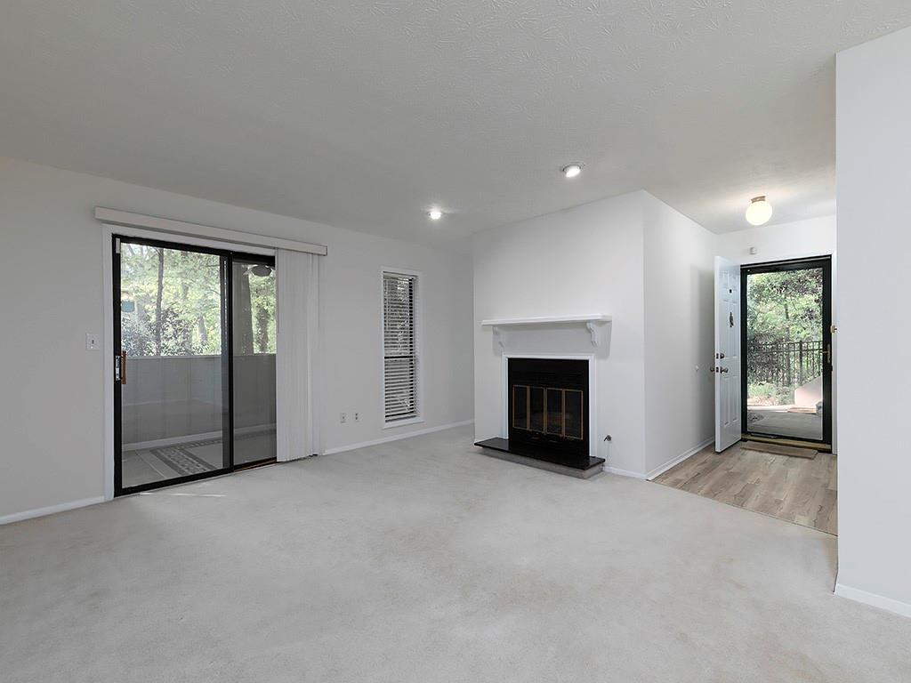 1316 Wynnes Ridge Circle Southeast Marietta, GA 30067 - Photo 5 of 29 an empty room with windows and fireplace