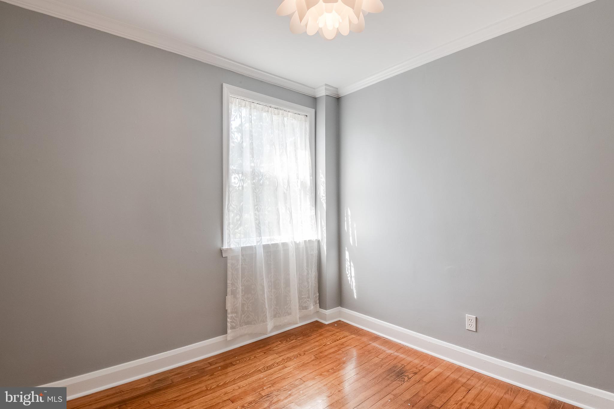 207 Blenheim Road Baltimore, MD 21212 - Photo 15 of 37 Bedroom One w/ hardwood and fresh paint