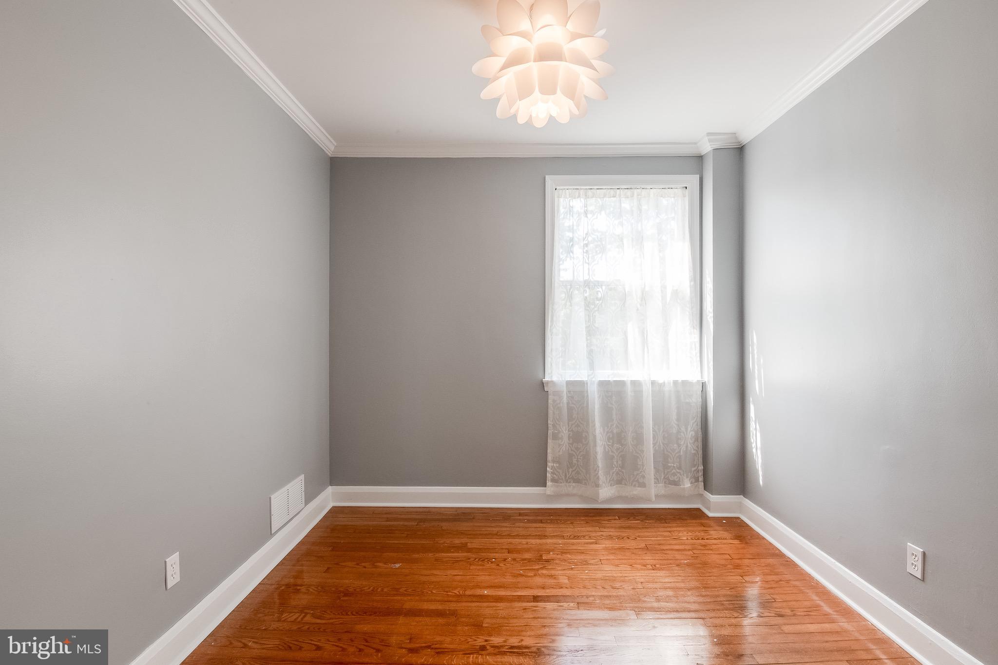 207 Blenheim Road Baltimore, MD 21212 - Photo 4 of 37 Bedroom One w/ hardwood and fresh paint