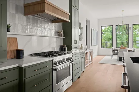 a kitchen with stainless steel appliances granite countertop a stove and a sink