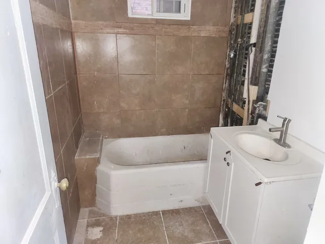 a bathroom with a bathtub and sink