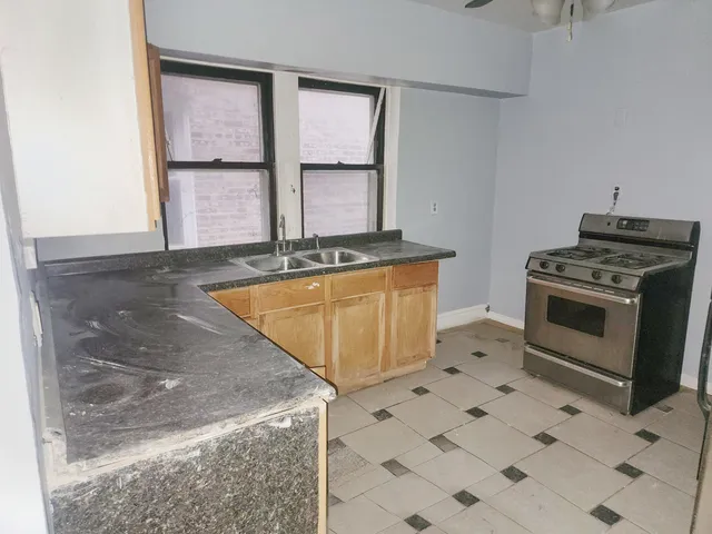 a kitchen with a stove a sink and a refrigerator