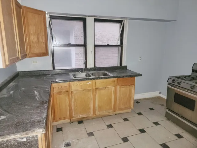 a view of a kitchen with sink and washing machine