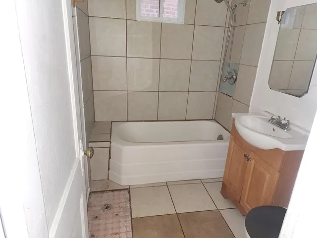 a bathroom with a bathtub and shower