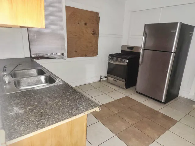 a kitchen with a refrigerator sink and stove