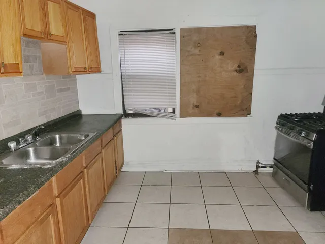 a kitchen with a sink a stove and a microwave
