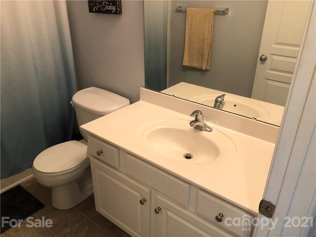 123 Chimney Rock Lane Fort Mill, SC 29708 - Photo 16 of 30 a bathroom with a sink a toilet and mirror