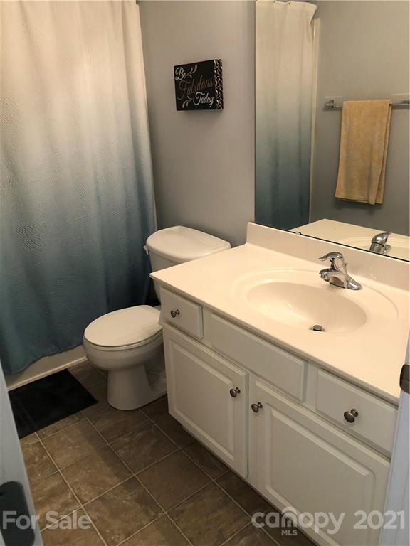 123 Chimney Rock Lane Fort Mill, SC 29708 - Photo 17 of 30 a bathroom with a sink a toilet and mirror
