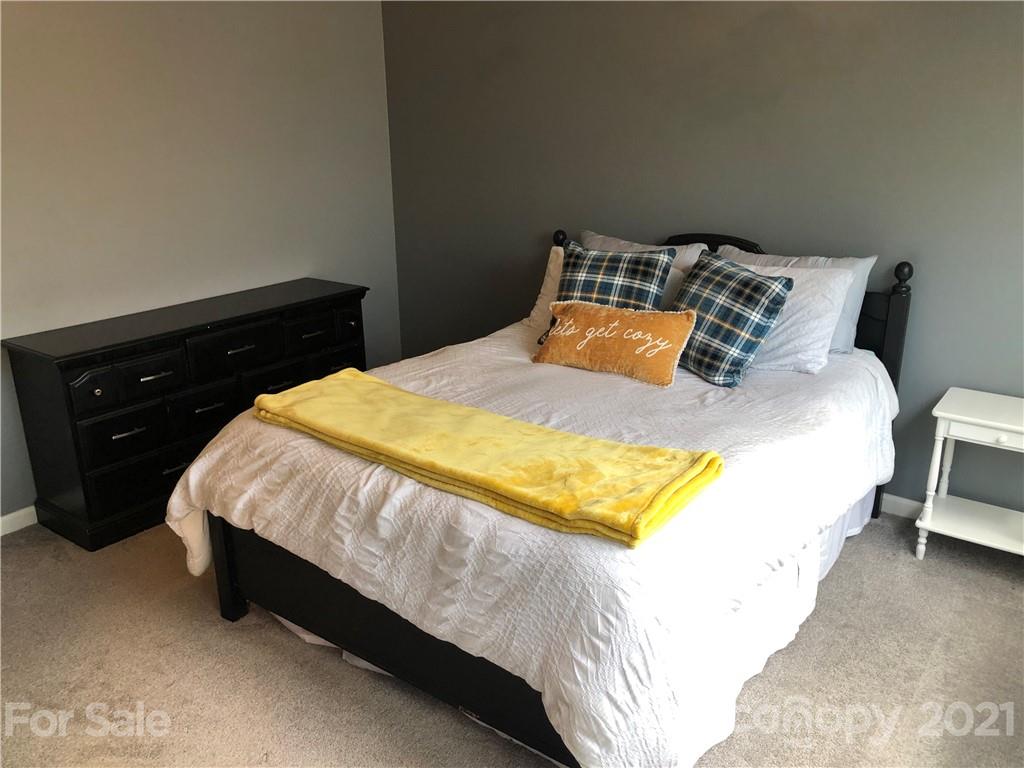 123 Chimney Rock Lane Fort Mill, SC 29708 - Photo 24 of 30 a bed sitting in a bedroom next to a lamp and dresser