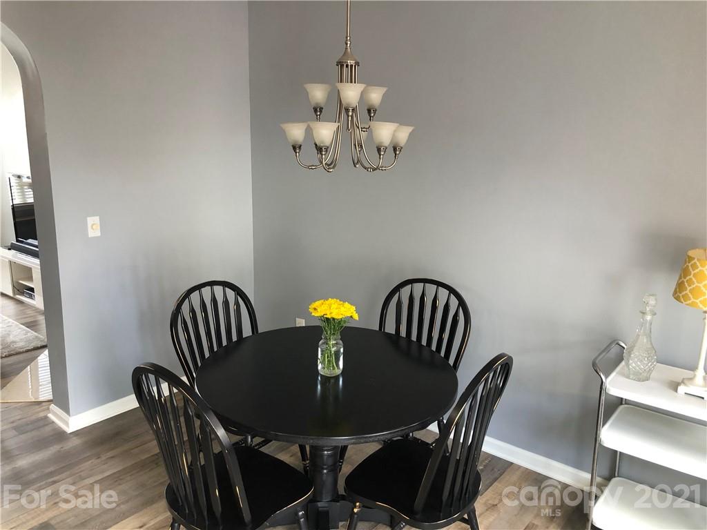 123 Chimney Rock Lane Fort Mill, SC 29708 - Photo 6 of 30 a view of a dining room with furniture a chandelier and wooden floor