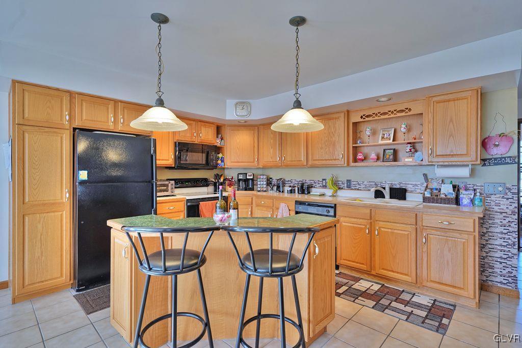 3021 Werner Road Nazareth, PA 18064 - Photo 13 of 41 a kitchen with stainless steel appliances granite countertop a refrigerator a stove a sink dishwasher and a wooden cabinets