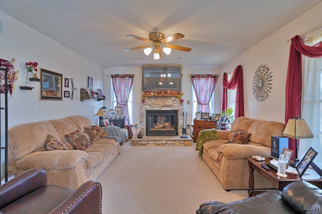 3021 Werner Road Nazareth, PA 18064 - Photo 6 of 41 a living room with furniture a fireplace and a chandelier