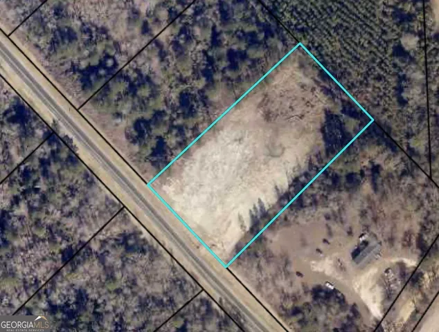 a view of a backyard with wooden floor and fence