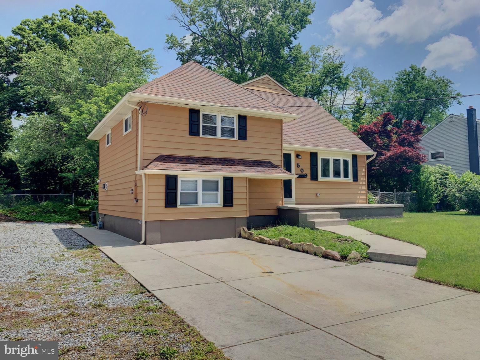 509 Spruce Avenue Pitman, NJ 08071 - Photo 3 of 25 a front view of a house with a yard and garage
