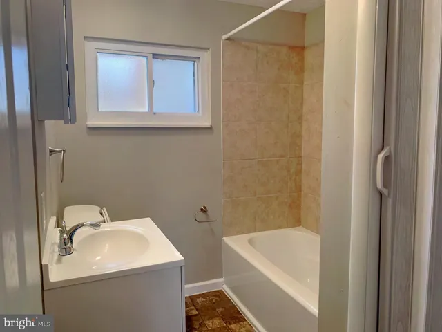 a bathroom with a sink a toilet and bathtub
