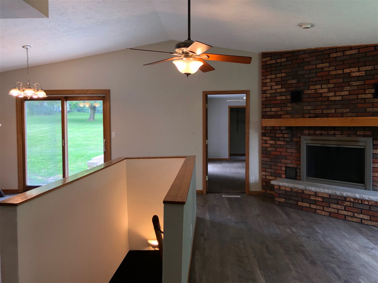 1733 Lake Summerset Road Davis, IL 61019 - Photo 7 of 24 a view of a livingroom with a fireplace wooden floor and a ceiling fan