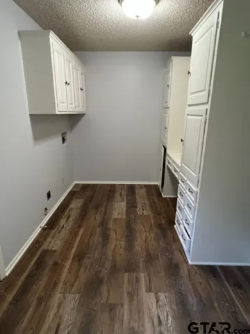 a view of kitchen with wooden floor and electronic appliances